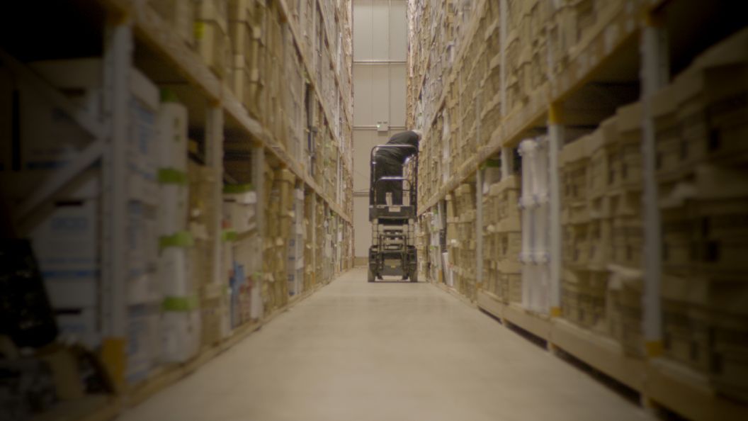 Person removing a box from shelves